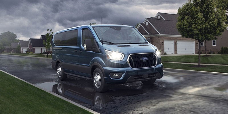 Ford Transit Passenger Wagon parked on a wet street