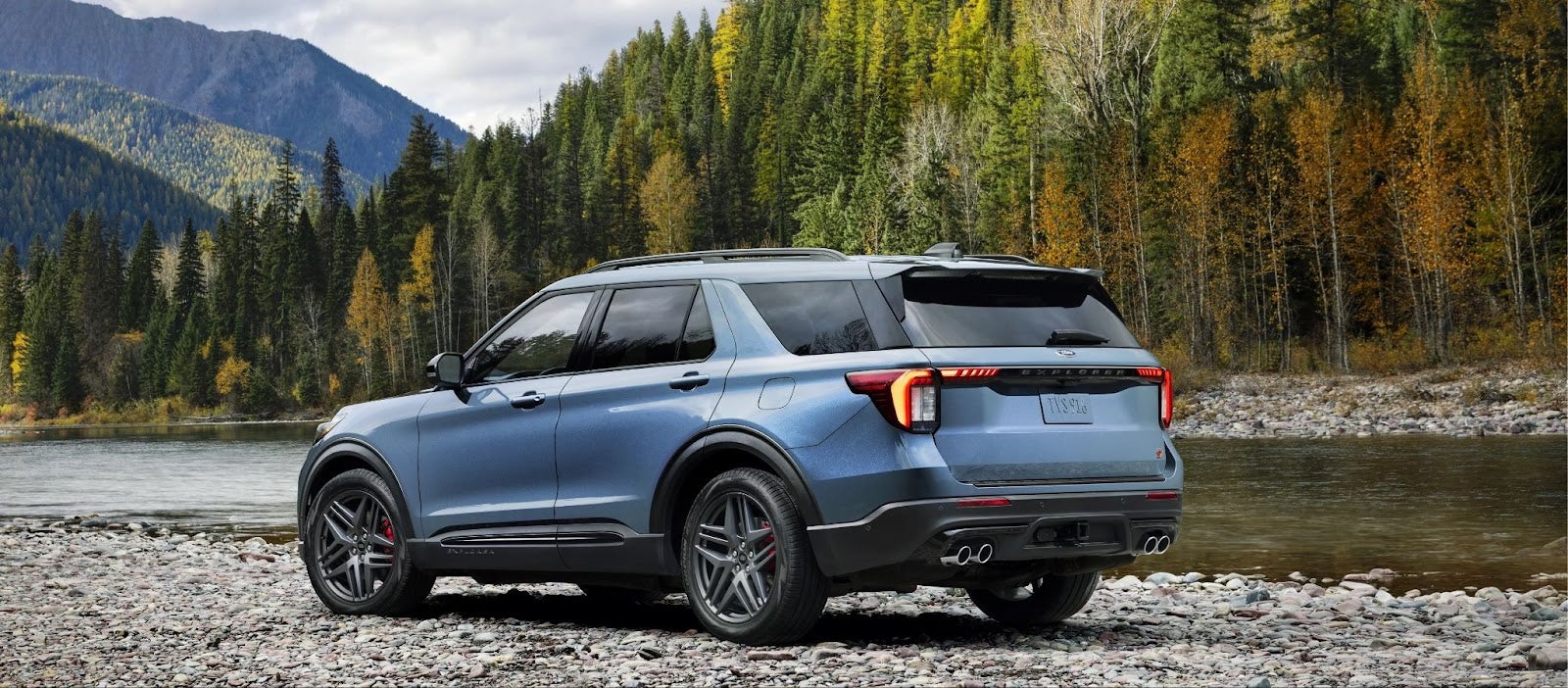 Ford Explorer SUV near water and mountains