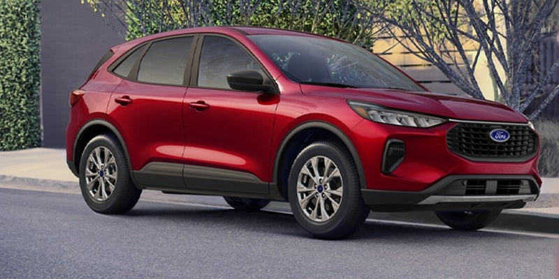 Red Ford Escape SUV parked on a paved street, angled slightly towards the right
