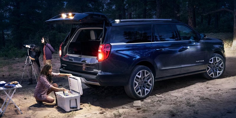 Ford Expedition parked at night with tailgate open