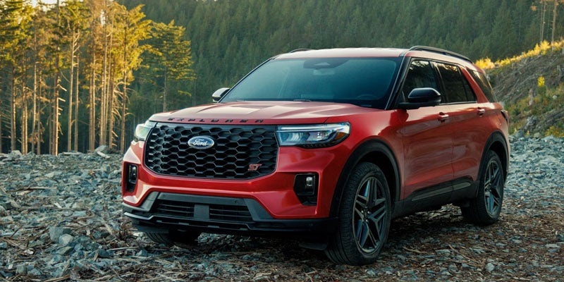 Ford Explorer SUV driving near trees