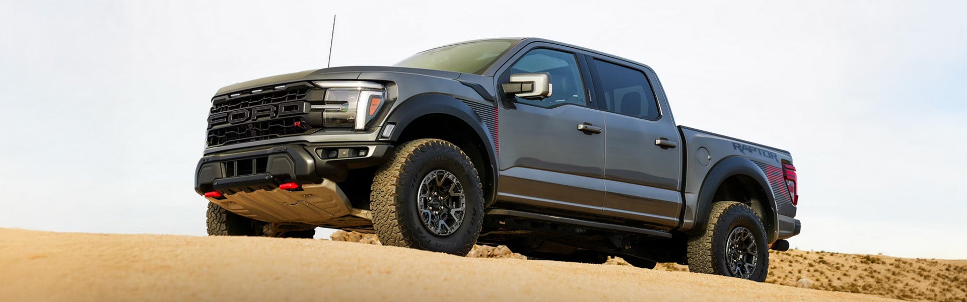 Ford F-150 Raptor pickup truck on sand