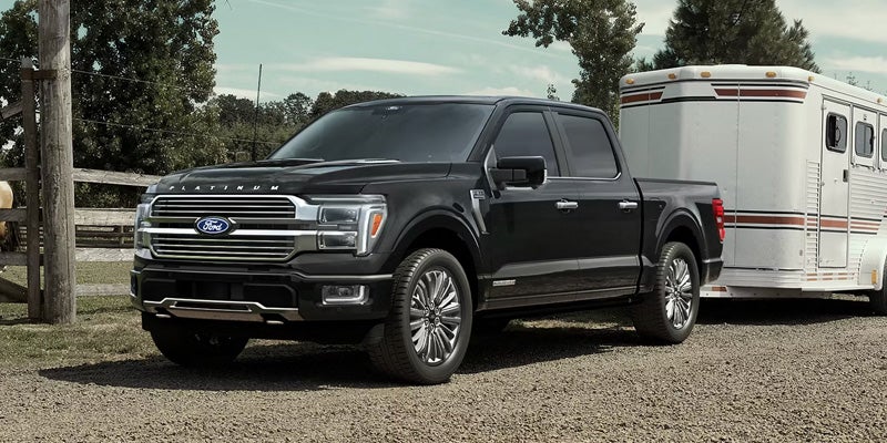 Dark grey Ford F-150 towing a trailer