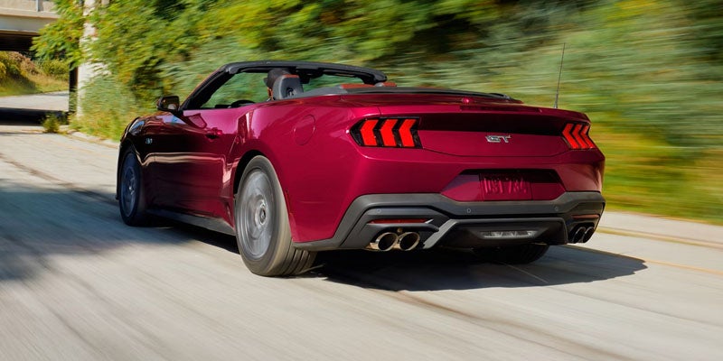 Rear view of Ford Mustang convertible driving