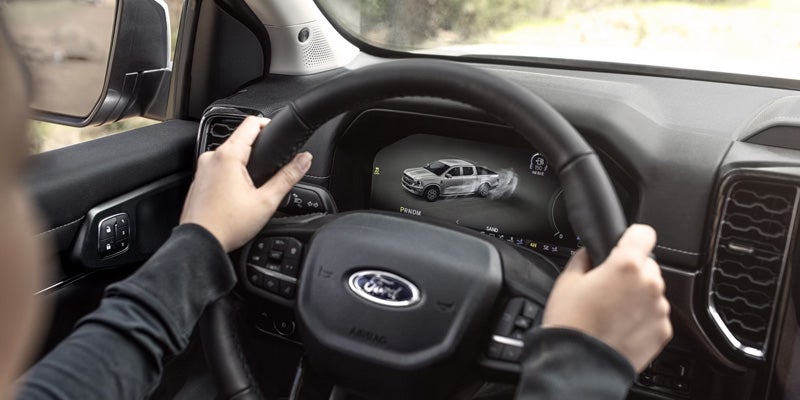 Driver holding steering wheel inside Ford Ranger