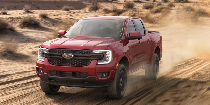 Ford Ranger driving across dirt ground
